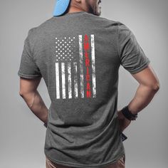 This American Flag Tee with design on the back is soft, sturdy and a stylish way show your patriotic pride and love for America! Wear it to the gym, a day working outdoors or backyard barbecue. It's a comfy casual way to make a statement and great addition to your patriotic apparel collection. It's made of 100% ring-spun cotton and is soft and comfy. The double stitching on the neckline and sleeves add more durability to what is sure to be a favorite! This Gildan Men's shirt fits true to size fo Casual Tops With American Flag For Veterans Day, Casual American Flag Tops For Veterans Day, Cotton Sports T-shirt With Flag Print, Sports T-shirt With Flag Print In Cotton, Sports T-shirt With Flag Print, American Flag Cotton T-shirt For Streetwear, American Flag T-shirt With Relaxed Fit, American Style T-shirt With American Flag And Relaxed Fit, American Flag Relaxed Fit T-shirt