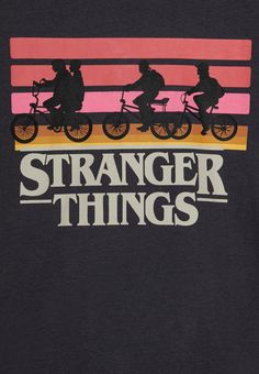 the back of a black shirt that says,'strange things'with three people riding bikes