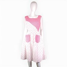 This fun, retro vintage sun-dress from the 1980s epitomizes summer chic.  It features a relaxed sleeveless bodice and a square neck. The waist is elasticated for a comfortable and adjustable fit, leading into a flared skirt that falls below the knee.  Made from white cotton material, in a playful dark pink polka dot and stripe print. Sold in excellent condition.  Approximate sizing: Medium - (M) UK: 12 US: 10 EU: 40 Measurements: bust: 40" waist: 26-32" hips: free length: 43" Thank you for your Summer Polka Dot Dress With Pockets, White Cotton Sundress For Picnic, Vintage White Sleeveless Sundress, White Sleeveless Vintage Sundress, Retro Cotton Sundress For Beach, Retro Cotton Sundress For Summer, Vintage White Cotton Sundress, Vintage Sundress For Summer Picnic, Vintage Summer Sundress For Picnic