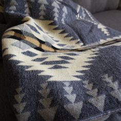 a blanket is laying on top of a couch