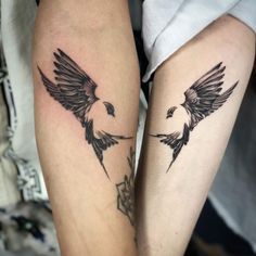 two black and white tattoos on both legs with birds flying above them, one is holding the other's hand