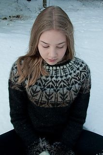 a young woman sitting in the snow with her eyes closed, wearing a black and white sweater