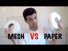 a man holding two rolls of toilet paper with the words mesh vs paper on it