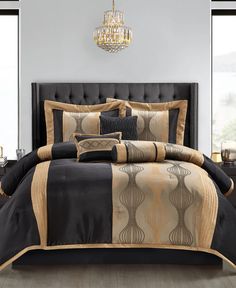 black and gold bedding with chandelier in the background