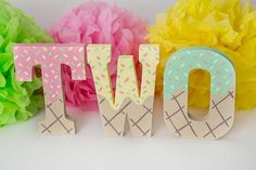 the word wow spelled out with ice cream cones and tissue pom - poms