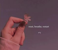 a person holding a small butterfly in their hand with a quote on the side that says rest, breathe, rest