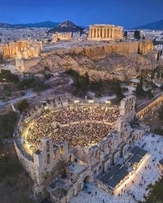 an aerial view of the acrobatic theatre at night in front of the partheny