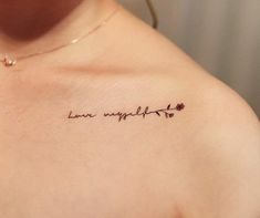 a woman's chest with the words love yourself written in cursive writing