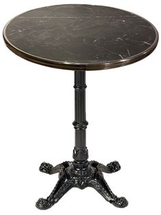 a black marble top table with an ornate base