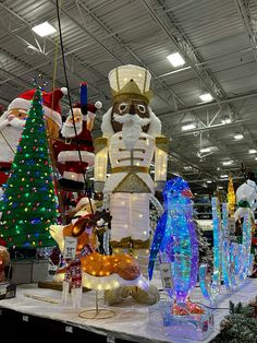 an assortment of christmas decorations on display in a store with lights and snowman figurines