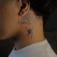 a woman with a spider tattoo on her neck