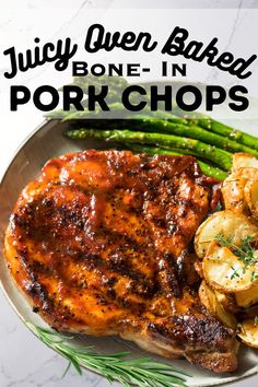 juicy oven baked pork chops on a plate with potatoes and asparagus for garnish