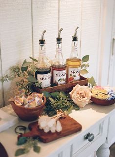 a table topped with bottles of liquor and flowers