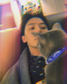 a blurry photo of a man and his cat