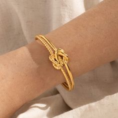 Introducing our Knot Cuff Bracelet, a crucial enhancement to your collection of fine accessories! These unique bracelets are meticulously crafted from high-grade 18k Gold Plated overlay on Stainless Steel, ensuring enduring durability and sophisticated elegance. Unique Bracelets, Ring Sizer, Base Metal, Cuff Bracelet, High Grade, Anklets, Knot, 18k Gold, Gold Plate