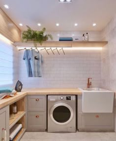 a washer and dryer in a small room with white tiles on the walls