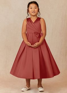 Ronda is our adorable flower girl dress cut from satin. She features a pleated V-neckline and a scoop back. The look is complete with an A-line skirt adorned with two bows. Satin Flower Girl Dresses, Rose Champagne, White Alabaster, Ankle Length Dress, Rust Dress, Dress Flower, Matte Satin, Flower Girl Dress, Dress Cuts