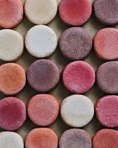 several different colored cookies sitting on top of each other