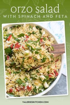 a bowl filled with rice and vegetables on top of a table next to a wooden spoon