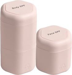 two pink salt and pepper shakers with the words body spf written on them