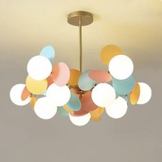 a chandelier hanging from the ceiling in a room with balloons all over it