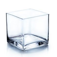 a square glass vase sitting on top of a table