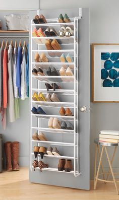 a white shoe rack with shoes hanging on it