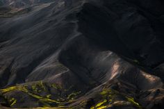 the mountains are covered in yellow and green moss