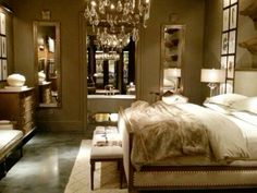 a bedroom with a chandelier hanging from the ceiling and a bed in it