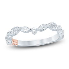 a white gold wedding ring with diamonds on it's sides and a rose - cut diamond