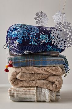 several blankets stacked on top of each other with snowflakes hanging from the ceiling