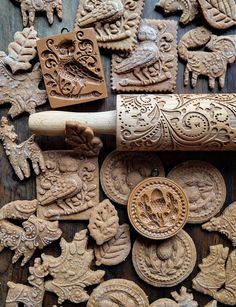 several carved wooden objects are laying on a table with a rolling pin in the middle