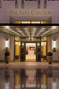 the ritz - carlton hotel in new york city is lit up at night with its lights on