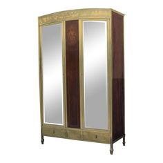 an armoire with mirrored doors and drawers