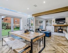 an open living room and dining area with sliding glass doors leading to the back yard