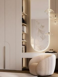 a white chair sitting in front of a mirror on top of a table next to a book shelf