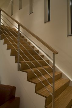 a wooden stair case with metal handrails in a home's living room