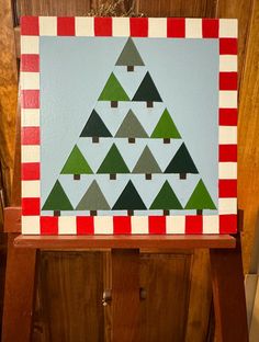 a christmas tree painted on top of a wooden cabinet