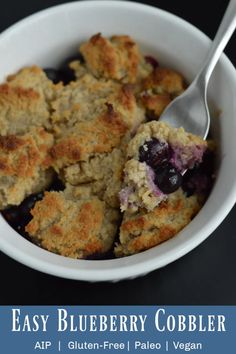 an easy blueberry cobbler in a white bowl with a spoon