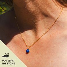 A woman wears a brilliant natural blue rock that's been polished and set in a 14k gold fill charm to wear on a chain. It's custom made, so you send the stone when ordering your jewelry. Minimalist Jewelry With Natural Stones In Round Pendant, Minimalist Jewelry With Natural Stone Round Pendant, Minimalist Jewelry With Round Pendant And Natural Stones, Minimalist Round Pendant Healing Jewelry, Minimalist Gemstone Charm Necklace With Round Pendant, Dainty 14k Gold Necklaces With Natural Stones, Minimalist Recycled Gold Necklace With Birthstone, Minimalist Birthstone Necklace In Recycled Gold, Minimalist Recycled Gold Birthstone Necklace