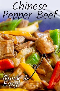 the chinese pepper beef is served in a blue bowl with red peppers and green peppers