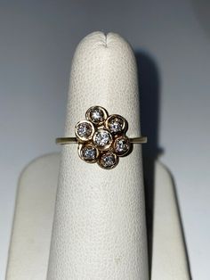 "Vintage flower diamond cluster ring in yellow gold stamped 14k. This unique style ring is a size 6.75 with a diamond weight of approximately .25cttw, diamond clarity SI2-3, color is I-J. Cluster measures ~1/2\" top to bottom." Cluster Flower Ring With Diamond Accents For Anniversary, Diamond White Cluster Diamond Ring Stamped 14k, Diamond Cluster Flower Ring In Yellow Gold, Yellow Gold Diamond Cluster Flower Ring, Heirloom 14k Cluster Diamond Ring, Cluster Diamond Ring Stamped 14k Gold, Anniversary Cluster Ring Stamped 14k, Sterling Silver Marcasite, Jade Ring