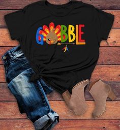 Women's Gobble T Shirt Turkey Shirts Gobble Tee Arrow Feathers Cute Thanksgiving TShirtThis women's gobble t shirt is cute, color, fun, and perfect for Thanksgiving. This colorful thanksgiving tshirt features the word 'Gobble' with a cute winking turkey as the 'o'. Perfect for all family members, commemorate your feast with matching shirts this year! Made of soft ring spun cotton and includes a cotton muslin drawstring gift bag.Direct to garment printed using the latest technology. Soft, ring sp Colorful Thanksgiving, Arrow Feather, Funny Thanksgiving Shirts, Turkey Shirts, Gobble Gobble, Family Thanksgiving, Festival Shirts, Thanksgiving Kids, Hoodie Size Chart