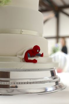 a wedding cake with a spiderman decoration on top