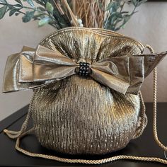 "Vintage Evening Purse in gold fabric textured materials with bow and some rhinestone  detail.  Drawstring in bucket  style with cord strap . Satin lining. Never worn Approximately 8\" x 8\"" Chic Party Bag With Ribbon Detail, Chic Party Bag With Ribbon, Elegant Formal Shoulder Bag With Bow, Gold Bucket Bag For Evening, Gold Bucket Shoulder Bag For Party, Elegant Bucket Shoulder Bag For Party, Elegant Gold Bucket Evening Bag, Elegant Party Bag With Satin Bow, Elegant Party Bags With Satin Bow