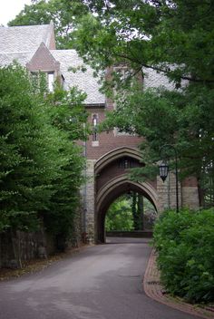 an arched brick building with trees surrounding it