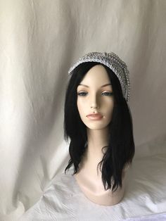 Absolutely beautiful! This is a silver vintage styled pearl beaded with rhinestone half hat fascinator perfect for weddings, Mother of the Bride hat, Bridal fascinator hat, Church hats, women convention hats, tea party, special occasion headpiece. E A S Y T O W E A R Forms to the contour of your head. Light weight One size fits all Silver pearl with rhinestone trim covered on a lightweight buckram base. S H I P P I N G : Expedited shipping upgrades are available at check out. We use Our local po Silver Evening Hat Headpiece, Silver Tall Crown Headpiece For Party, Glamorous Silver Headpieces For Party, Silver Structured Crown Headpieces For Party, Silver Headpiece With Structured Crown For Party, Party Headpiece With Rhinestones And Structured Crown, Party Headpieces With Rhinestones And Structured Crown, Glamorous Crystal Embellished Headband, Silver Glamorous Party Headband