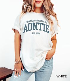 a woman wearing a white tee shirt with the words, promote from bestie to anette