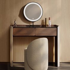 a white chair sitting in front of a mirror on top of a wooden dresser next to a table