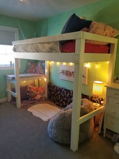 a bunk bed with some lights on it in a child's room or bedroom